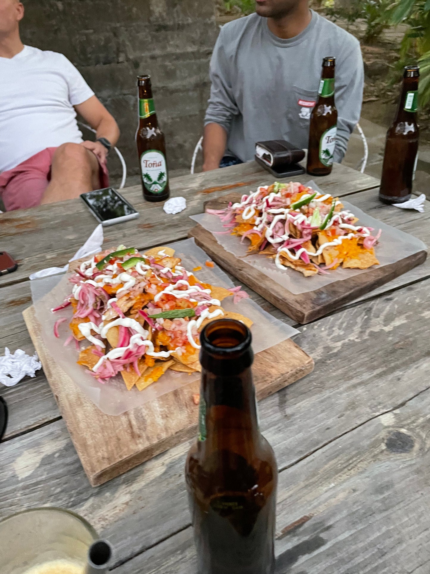 Nachos and beers on a wooden table in San Juan Del Sur.