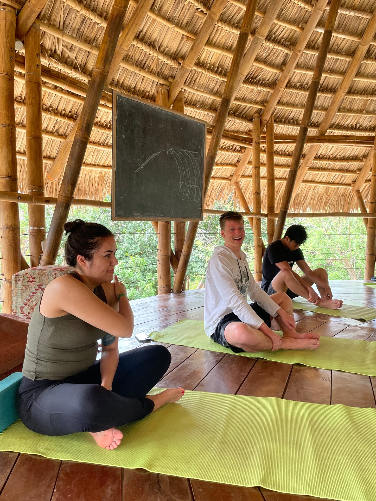 Trip participants having yoga lessons in a canopy in San Juan Del Sur.