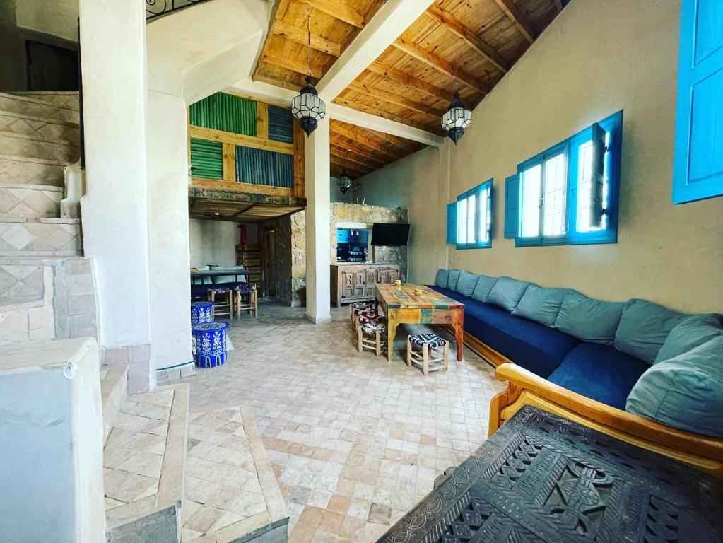 Long sofa and dining area of the Ocean View Taghazout hostel accommodation for small group travel.