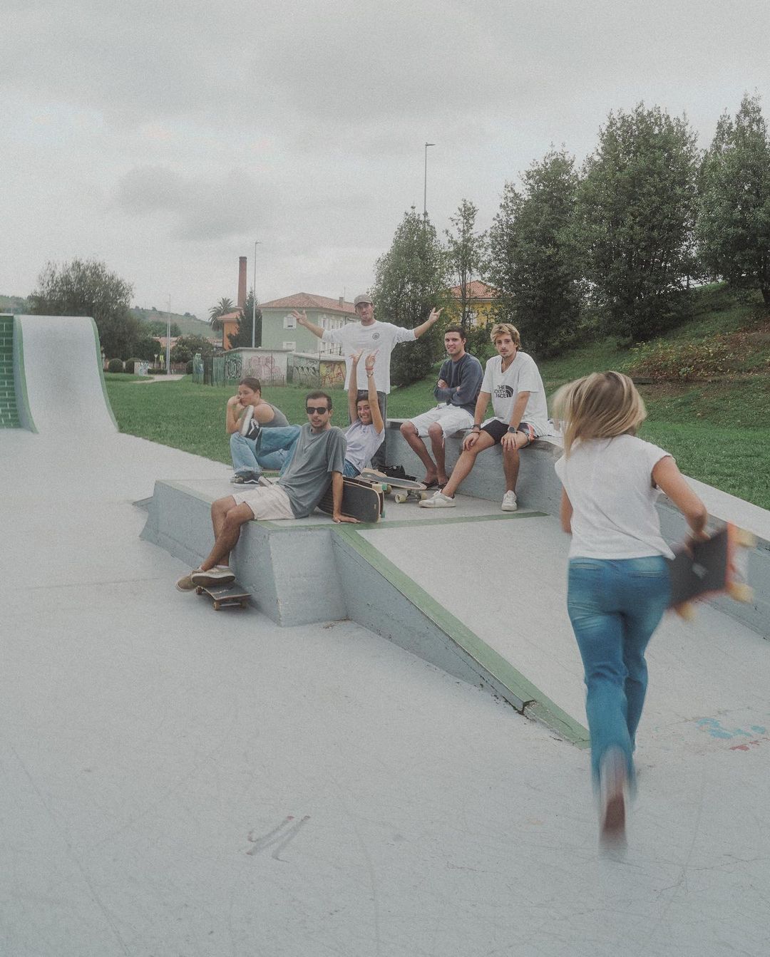 New friends skateboarding at a skate park during a group travel excursion in Cantabria.