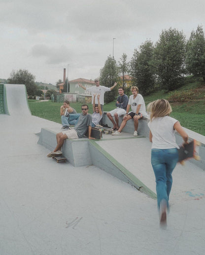 New friends skateboarding at a skate park during a group travel excursion in Cantabria.