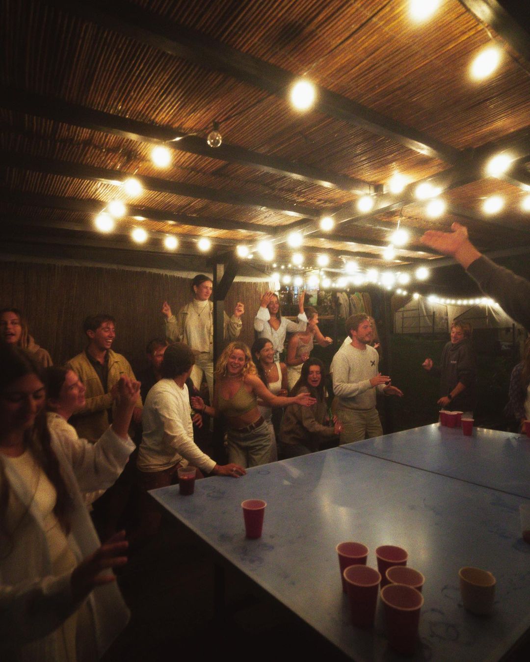 New friends partying and playing beer pong during their small group trip in Cantabria.