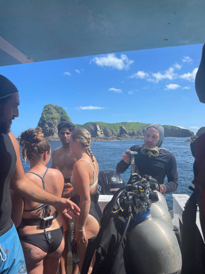 Small group travel participants on a boat preparing to go scuba diving in Islas Catalinas.