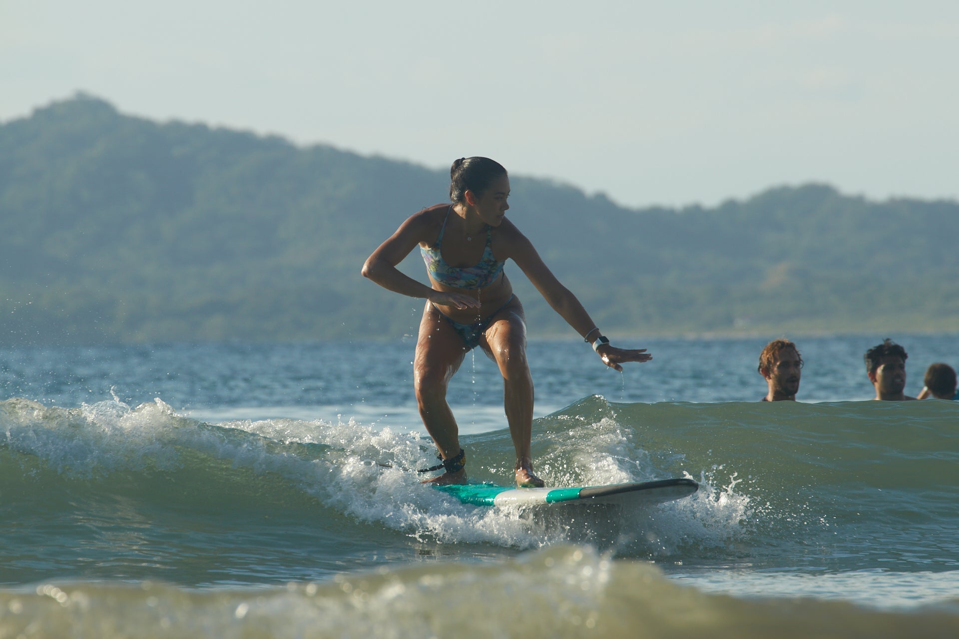 Girl surfing in Costa Rica during group trip surf lessons.