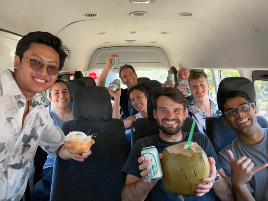 Small group trip participants with beers and coconuts in a van in San Juan Del Sur.