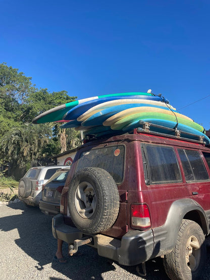 Surfboards stacked on a jeep for trip participants going surfing in Costa Rica.