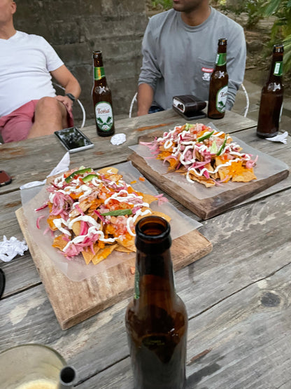 Nachos and beers on a wooden table in San Juan Del Sur.
