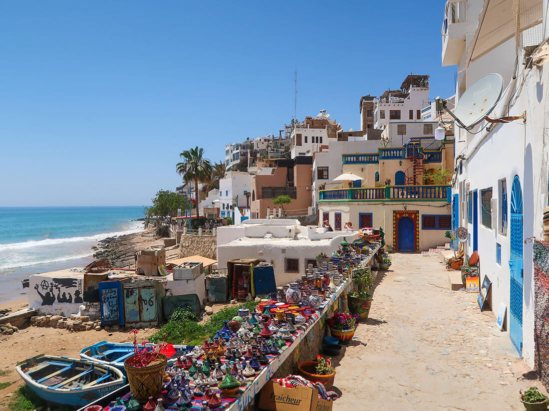 Taghzaout beachside homes with handmade items for sale along the street.