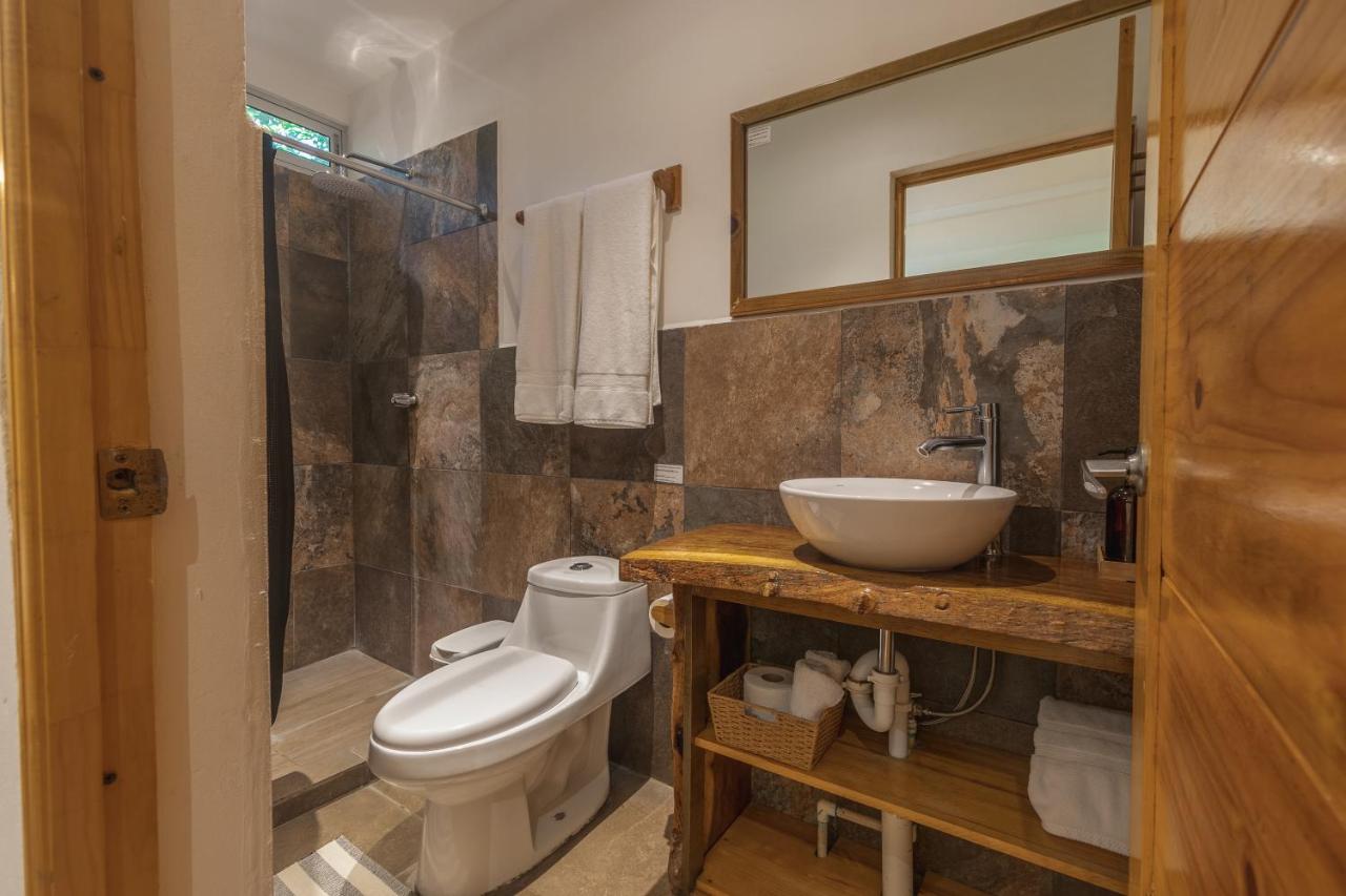 Bathroom with toilet shower and sink in the El Salvador small group trip accomodation.