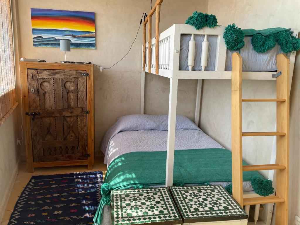 Bunk beds and dresser for two people in the Taghazout Ocean View hostel.