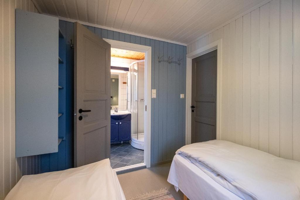 Double bedroom with beds and bathroom in rorbu cabins for the Lofoten small group trip. 