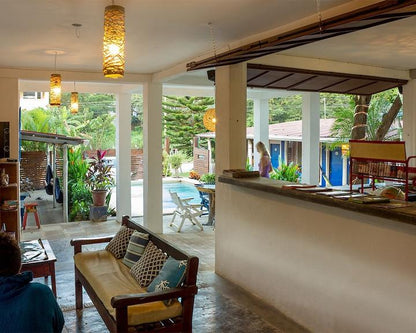 Outdoor bar and seating area of La Botella De Leche hostel in Tamarindo.