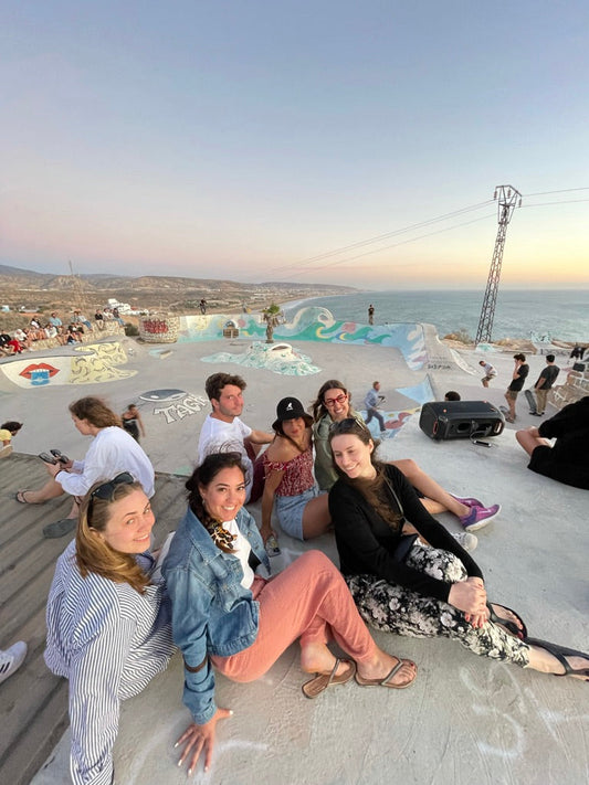 New friends smiling at a skatepark in Taghazout Morocco during a small group trip.