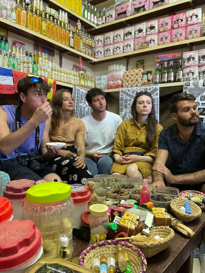Five trip participants surrounded by Moroccan spices on a group trip excursion.