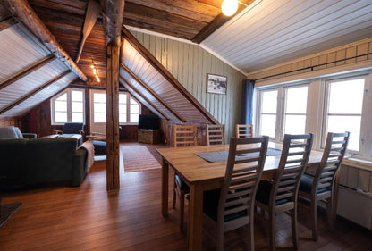 Sofa and dining table in the Svinoya Rorbuer cabins provided for the Lofoten small group trip.