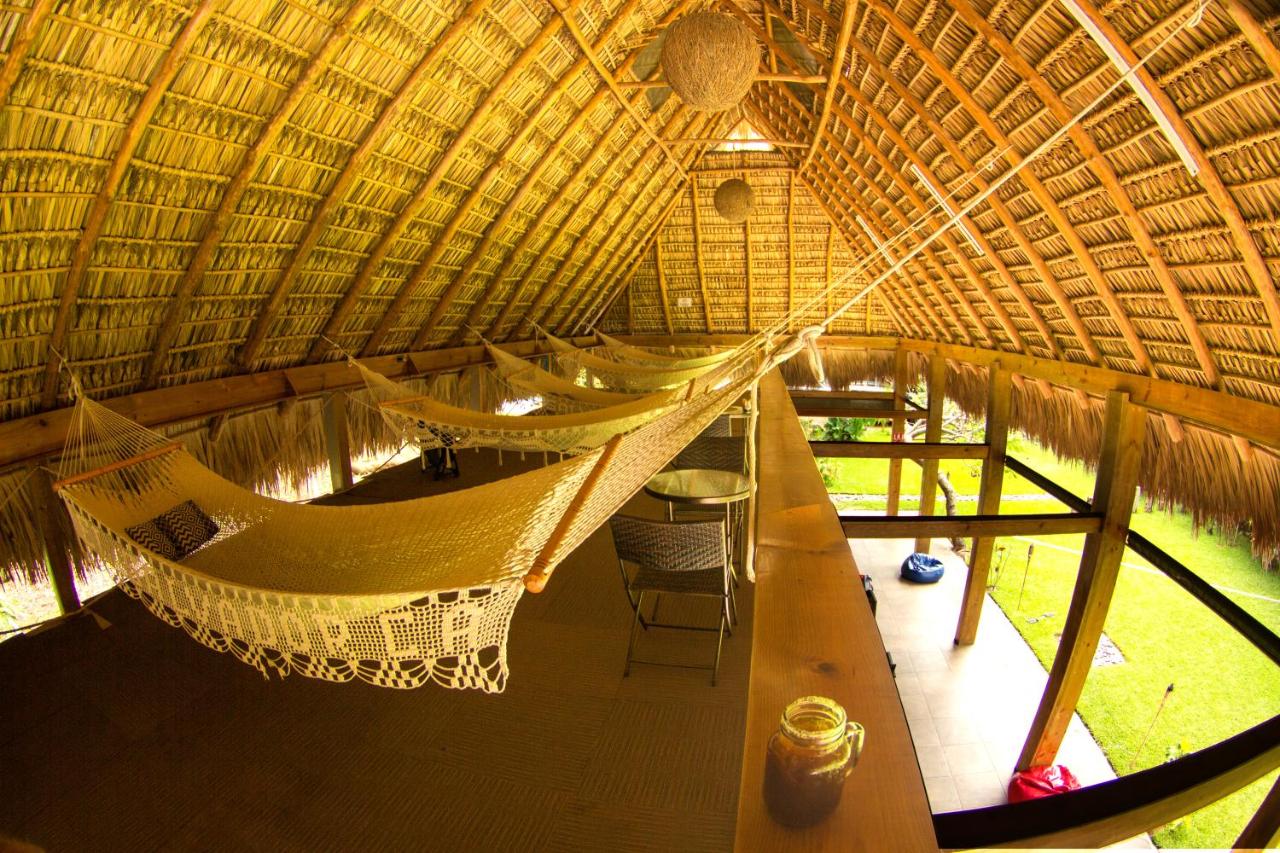 Four hanging hammocks in a lofted lounge area in the Michanti Hotel small group travel accommodation.