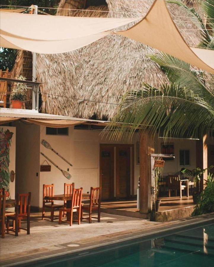 Outdoor dining area view near the pool of the Michanti Hotel in El Salvador.