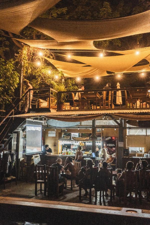 People enjoying the outdoor seating area of the Michanti hotel at night.