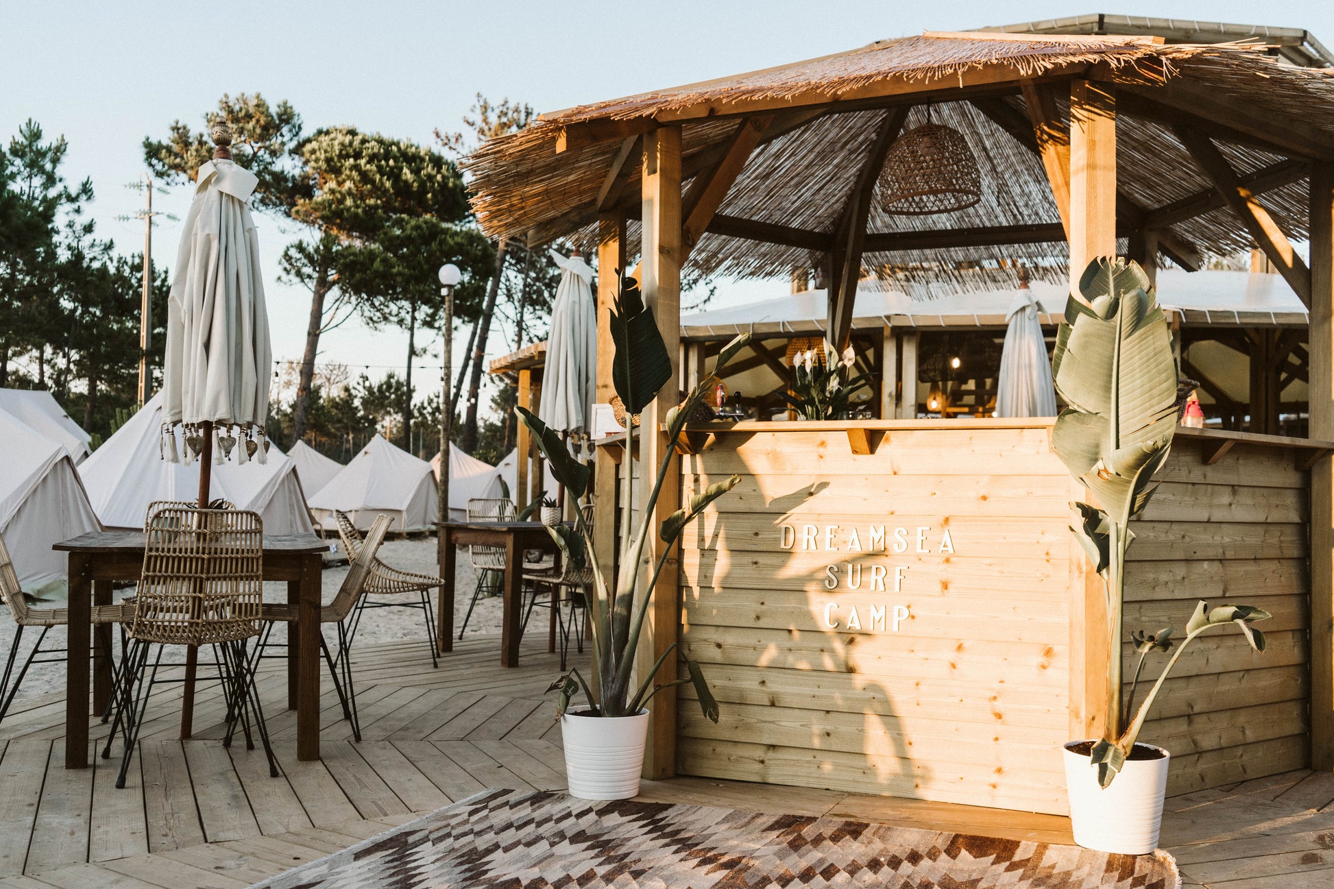 Outdoor seating and wooden bar canopy at the Dreamsea Surf Camp accommodation in Portugal for small group travel.