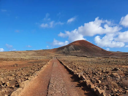 Dirt path leading to the Calderon Hondo crater in Fuerteventura during an excursion. 