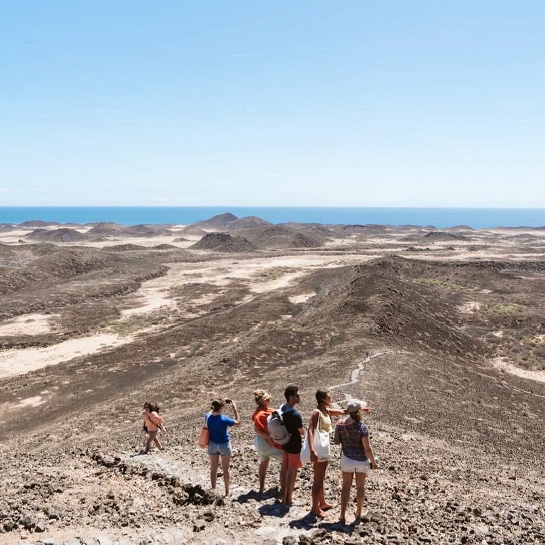 Small group trip participants hiking the landscape in Fuerteventura.