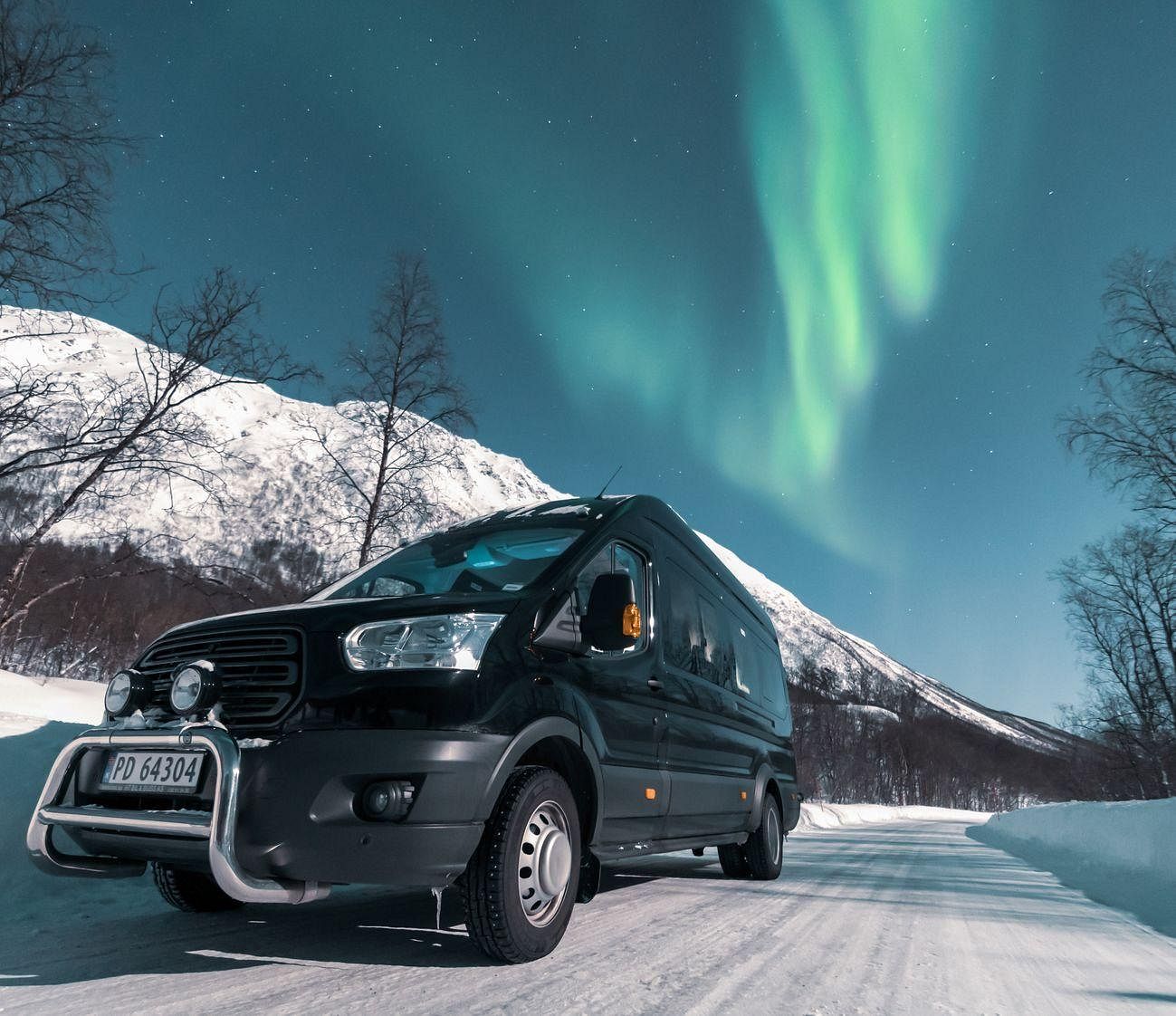Van chasing the northern lights in Tromso Norway on a small group trip.